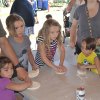 Kids pounding dough.